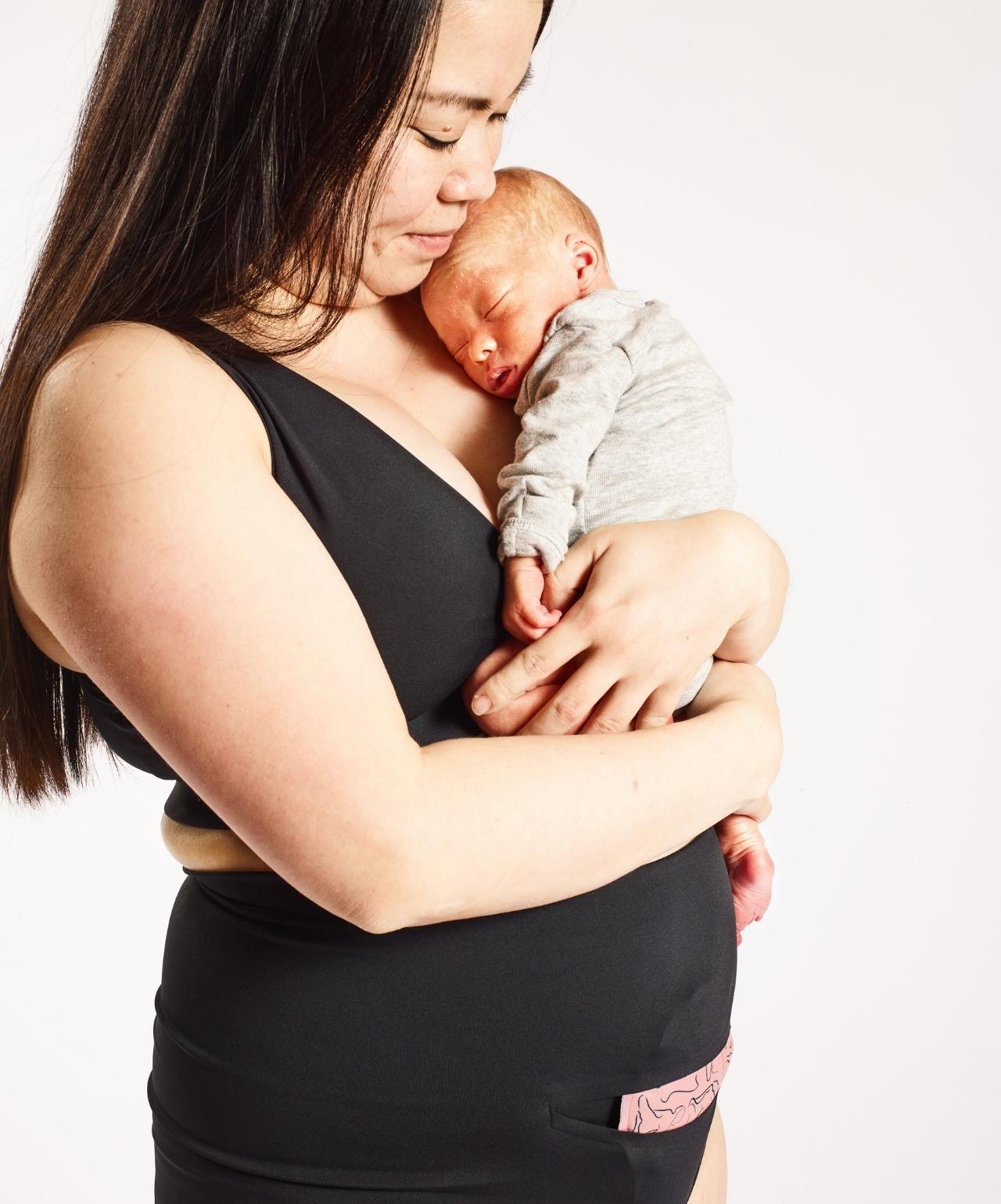 Mother holding baby while wearing FourthWear Underwear