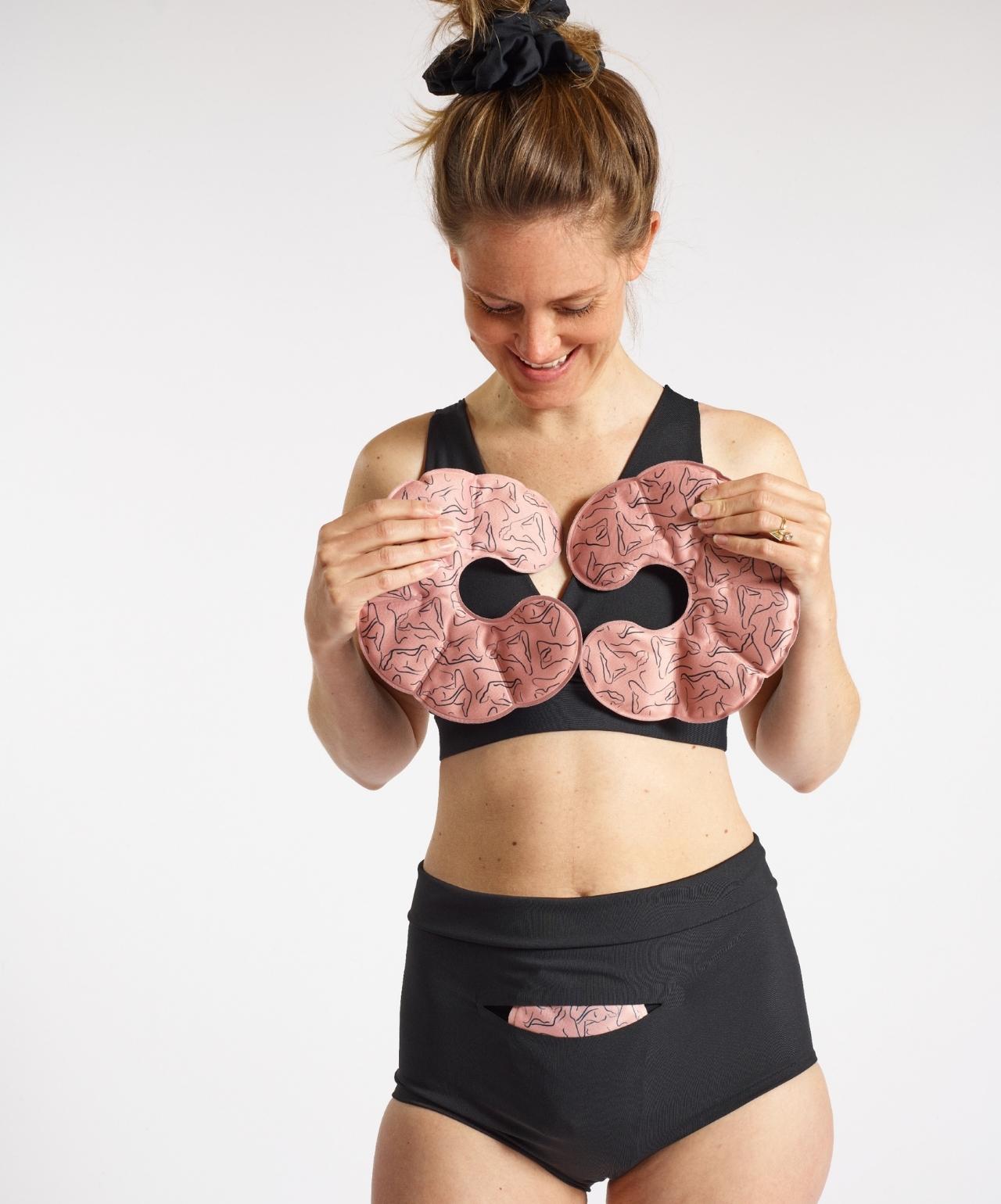 Woman wearing Nyssa postpartum bralette and underwear, holding reusable breast and chest ice-heat packs.