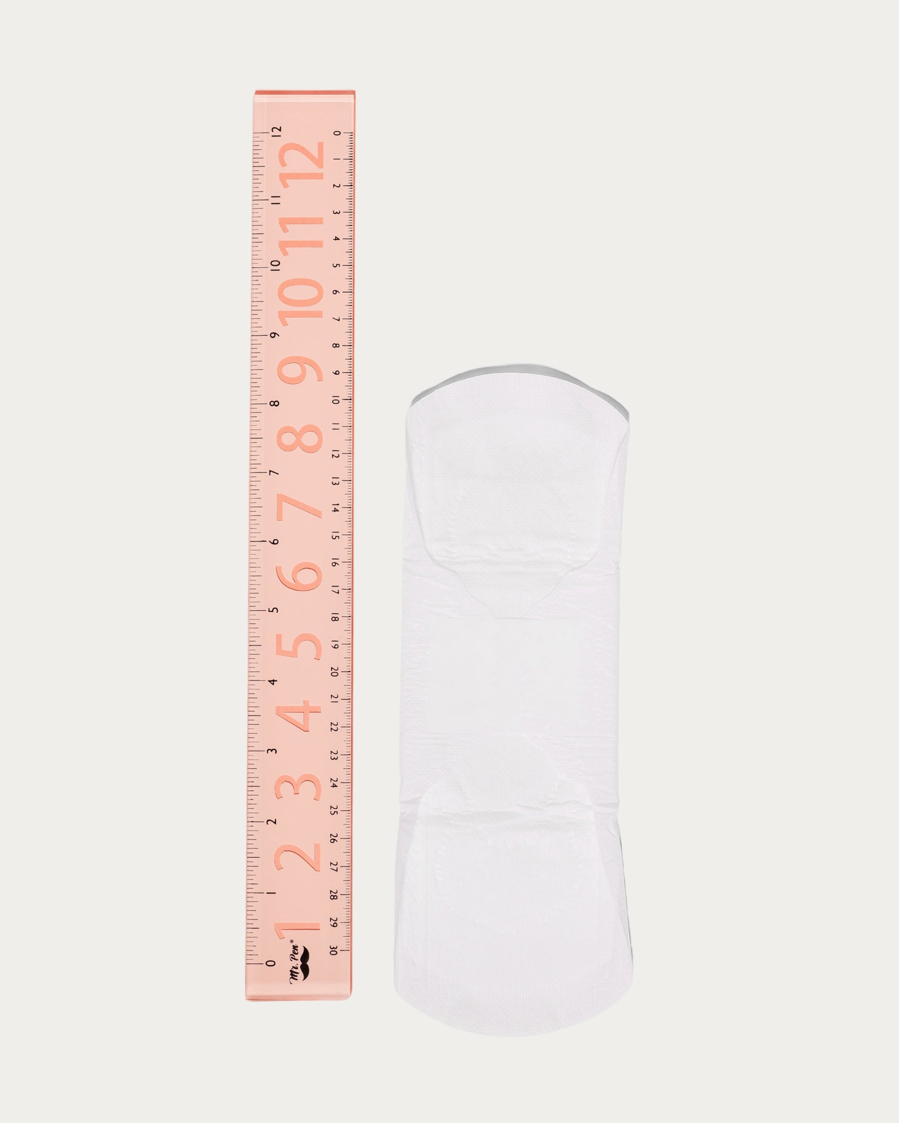 organic cotton pad next to a ruler for size reference, approximately 9 inches.