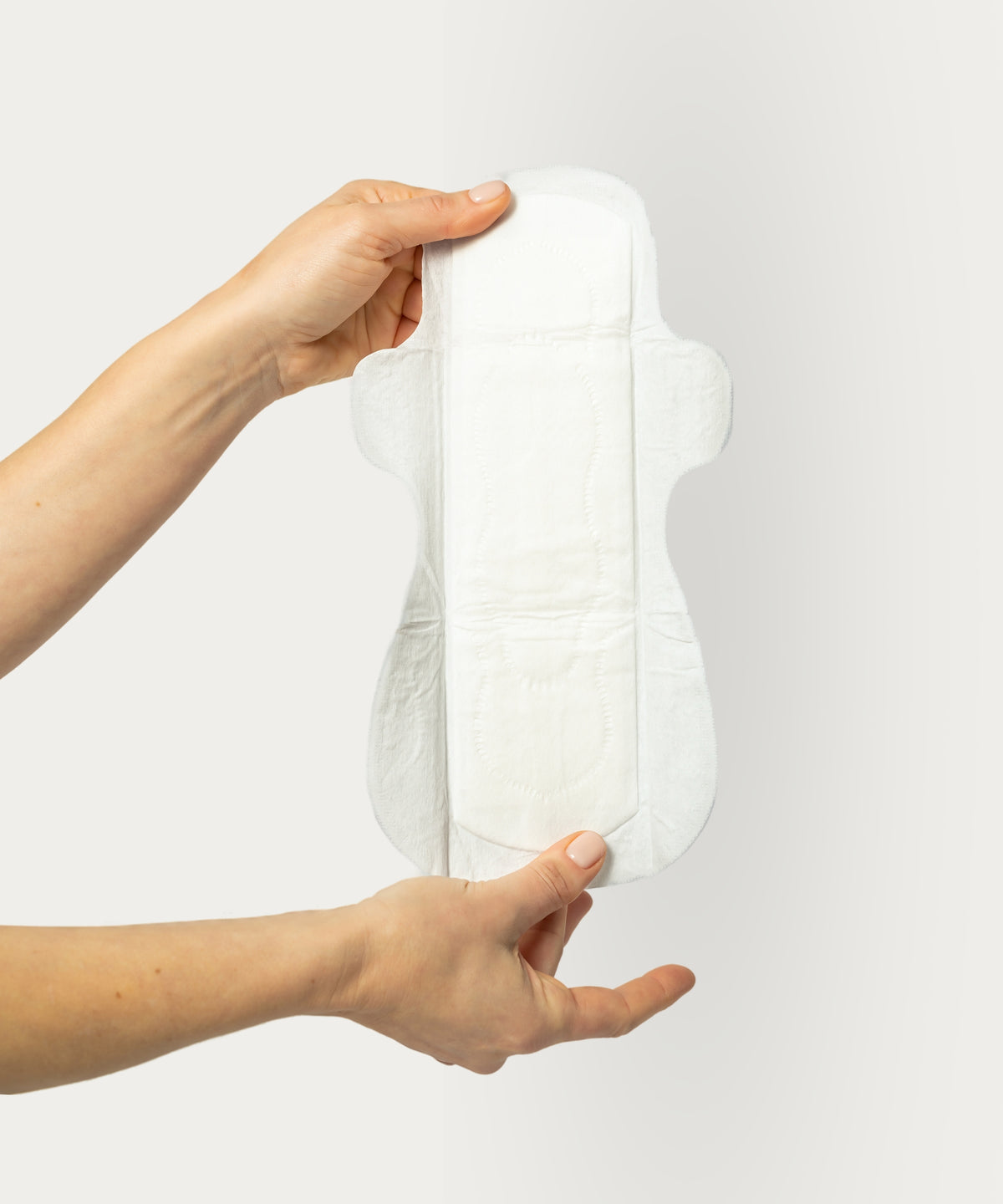 Hands holding Nyssa Organic Cotton Cover Overnight Period Pads